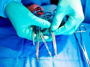 High angle view of a surgeon's hands holding surgical scissors